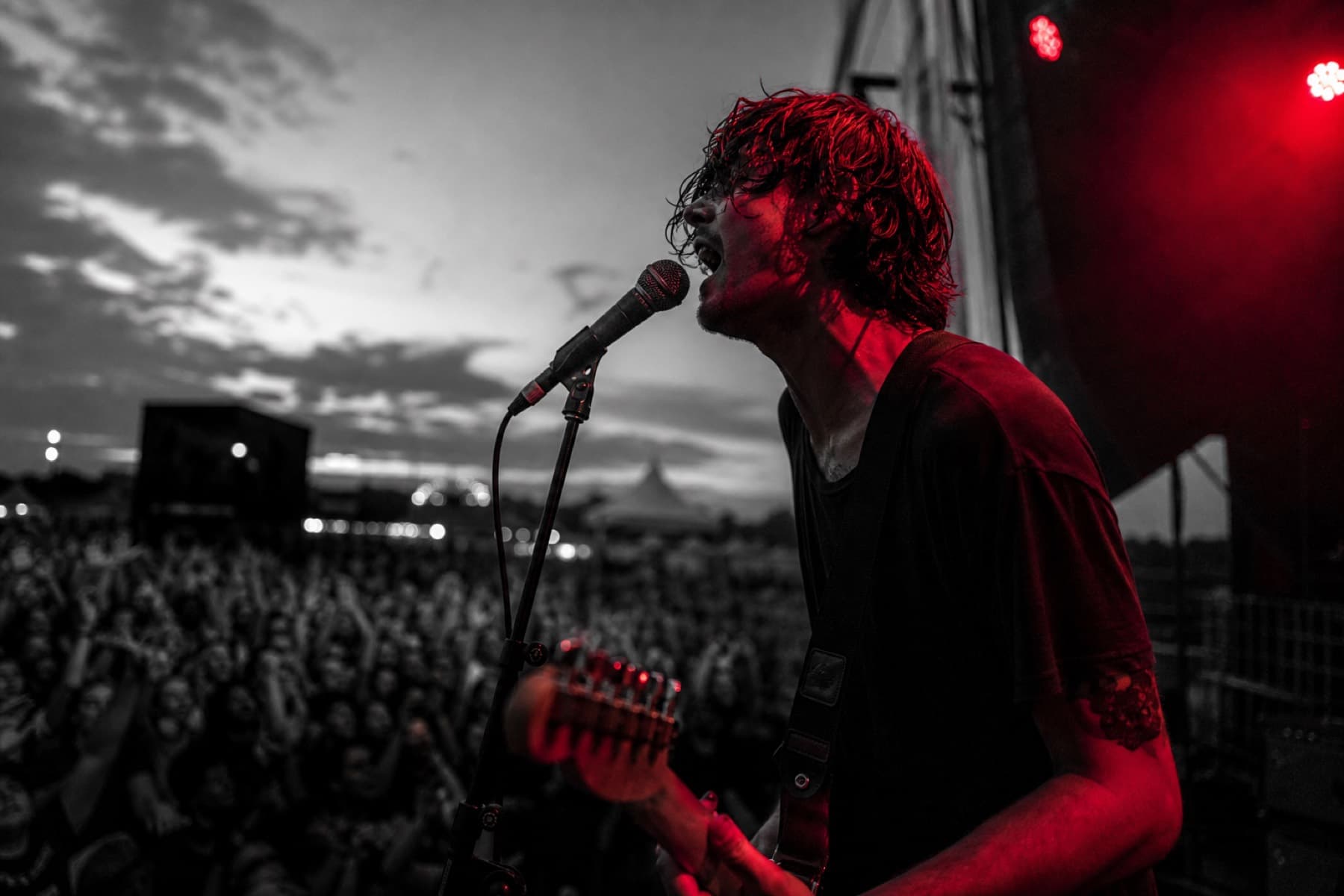 Live performer on the outdoor festival stage at dusk
